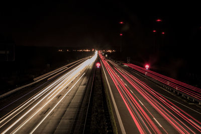 High angle view of light trails on multiple lane highway at night