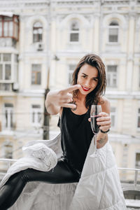 Portrait of smiling young woman using smart phone outdoors