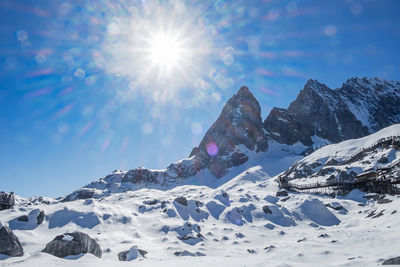 Scenic view of snowcapped mountains against sky on sunny day