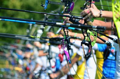 People aiming with bows during competition