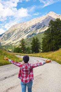 Rear view of woman walking on road