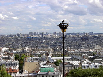 Cityscape against cloudy sky