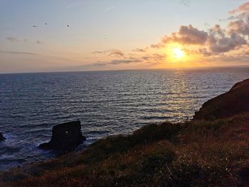 Scenic view of sea against sky during sunset