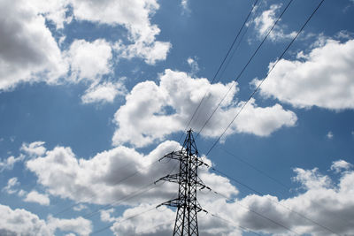 Low angle view of electricity pylon against sky