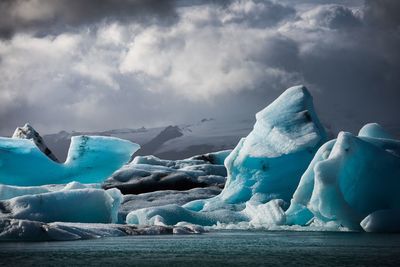 Scenic view of frozen lake against sky