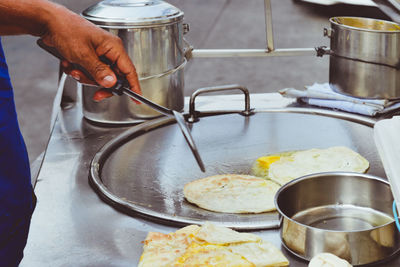 Midsection of man preparing food in kitchen