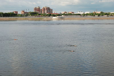 Scenic view of sea against sky in city