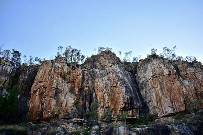 Low angle view of rocks against clear sky