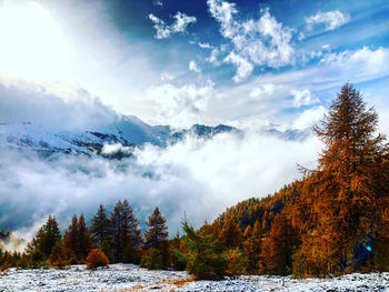 Scenic view of snow covered mountains against sky during autumn