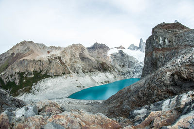 Scenic view of snowcapped mountains and glacier against cloudy sky