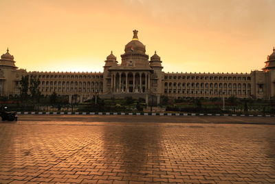 View of building in city against sky during sunset