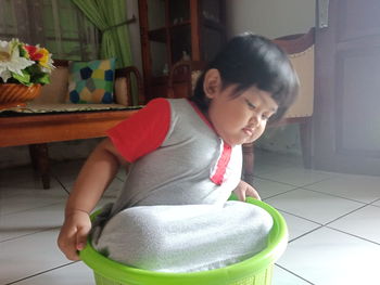 Cute girl sitting on floor at home