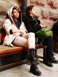 Young woman sitting on floor