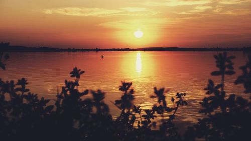 Scenic view of lake against sky during sunset