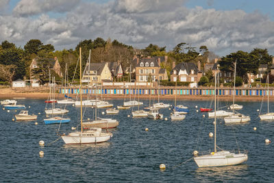 Boats moored in sea against sky