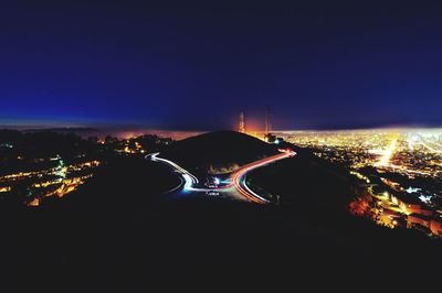 High angle view of illuminated city against sky at night