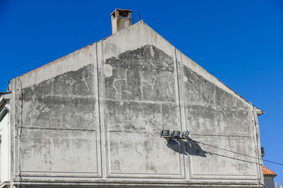 Low angle view of building against clear blue sky