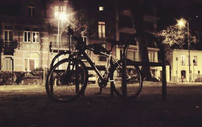 Bicycles in illuminated city at night