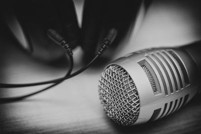 Close-up of microphone and headphones on table