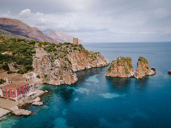 Scenic view of sea and rocks against sky