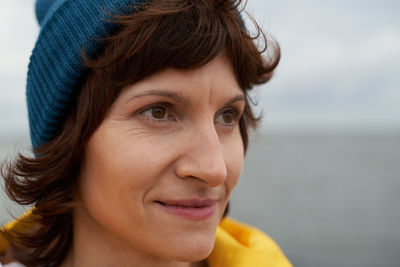 Crop closeup portrait of mature beautiful woman standing outdoors in nature.