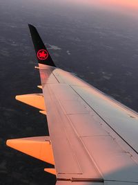 Airplane flying over sea against sky