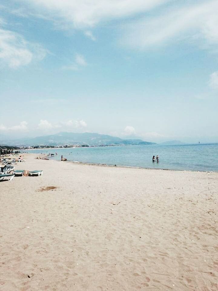 sea, beach, sand, water, sky, shore, horizon over water, tranquil scene, tranquility, scenics, beauty in nature, nature, incidental people, idyllic, vacations, blue, day, cloud, cloud - sky, coastline