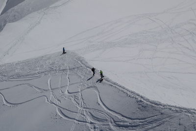 People skiing on snowcapped mountain