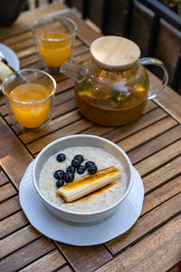 Breakfast with herbal sea buckthorn tea, oatmeal porridge and cottage cheese fritters with sauce.