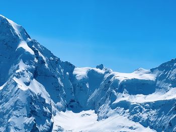 Scenic view of snowcapped mountains against clear blue sky, view over jungfrau into the eternal snow