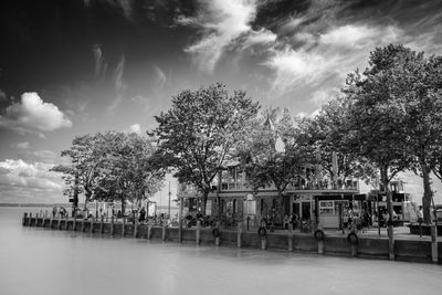 Scenic view of trees by building against sky