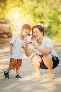 Mother and son take a photo by smartphone