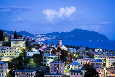 High angle view of townscape by sea against sky
