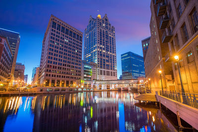 Reflection of illuminated buildings in city at night