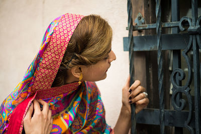 Beautiful woman looking though window