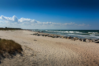 Scenic view of beach against blue sky