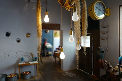 Illuminated light bulbs hanging at home