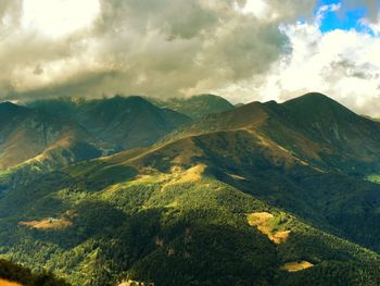 Scenic view of mountains against cloudy sky