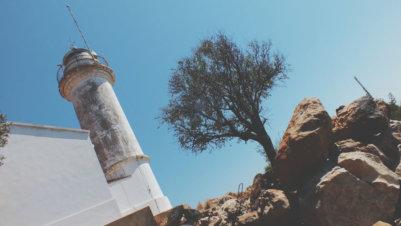 low angle view, sky, tower, built structure, building exterior, architecture, no people, tree, outdoors, day, city, nature