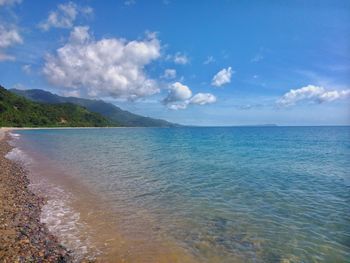 Scenic view of sea against cloudy sky