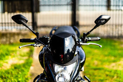 Close-up of motorcycle on field