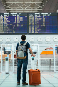 Young man waiting his flight at the airport