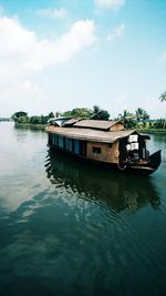 Boat in river against sky