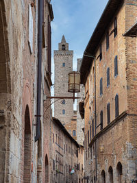 Details of bell towers and brick houses in san gimignano in tuscany, siena - italy.