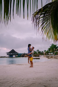 Full length of woman on beach against sky