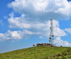 Traditional windmill on field against sky