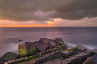 Scenic view of sea against romantic sky