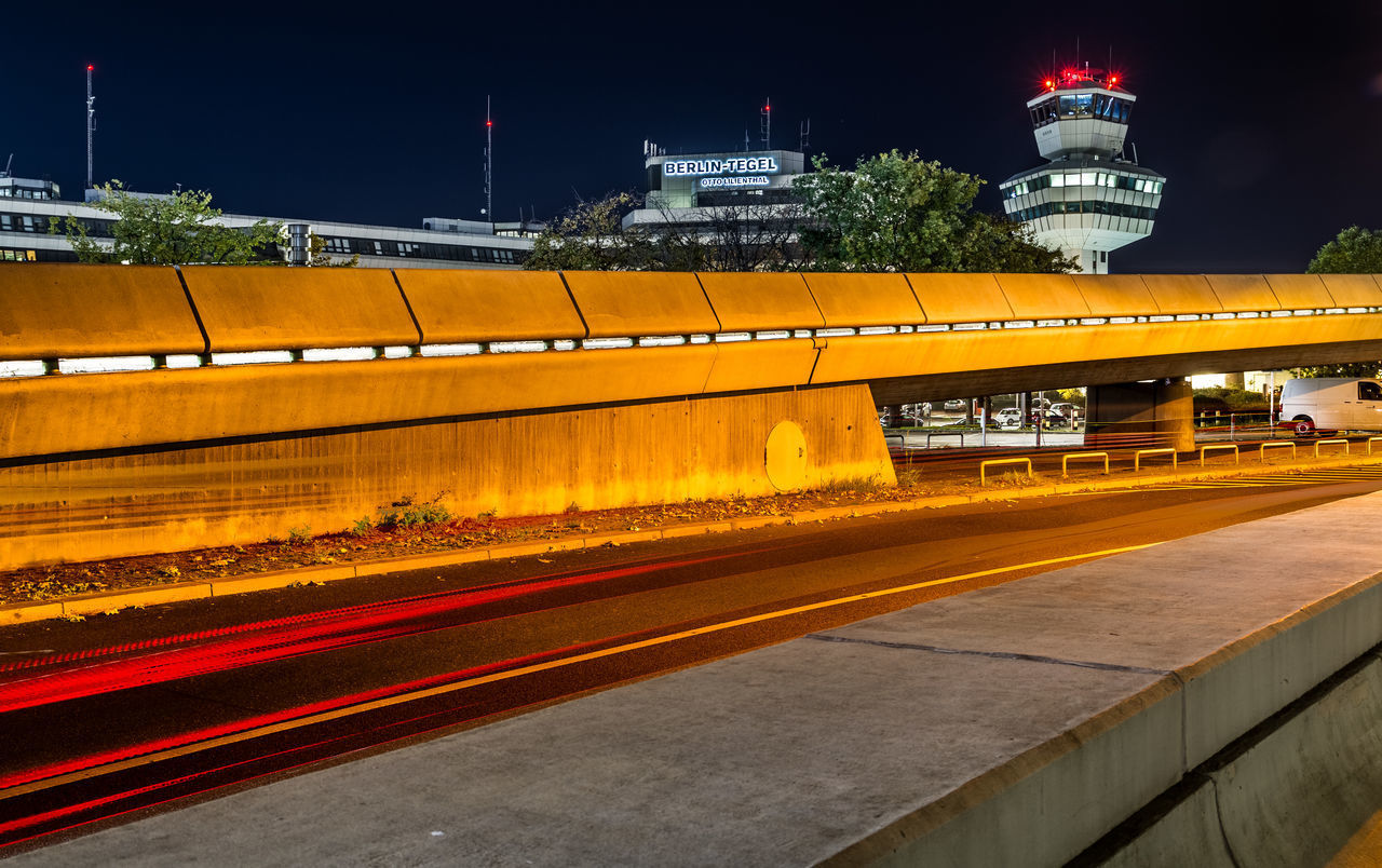 LIGHT TRAILS ON ROAD IN CITY