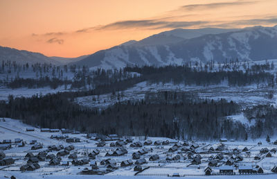 Scenic view of snow mountains against sky during sunset