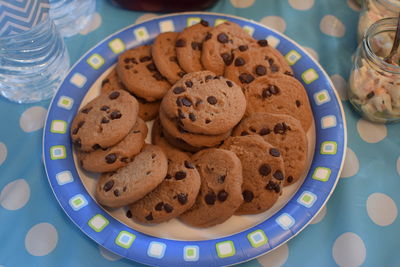 High angle view of cookies in plate on tablecloth